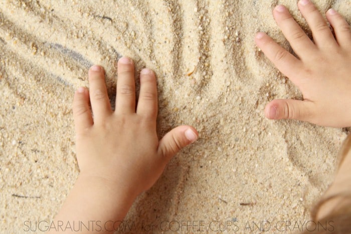 Sand story table and storytelling with sand. Sneak in handwriting this summer!